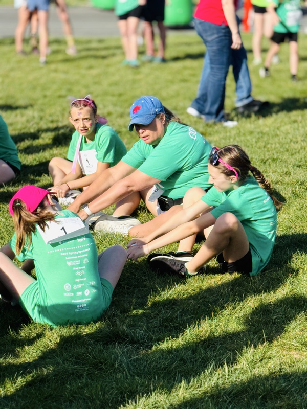 girls on the run coach and girls stretching