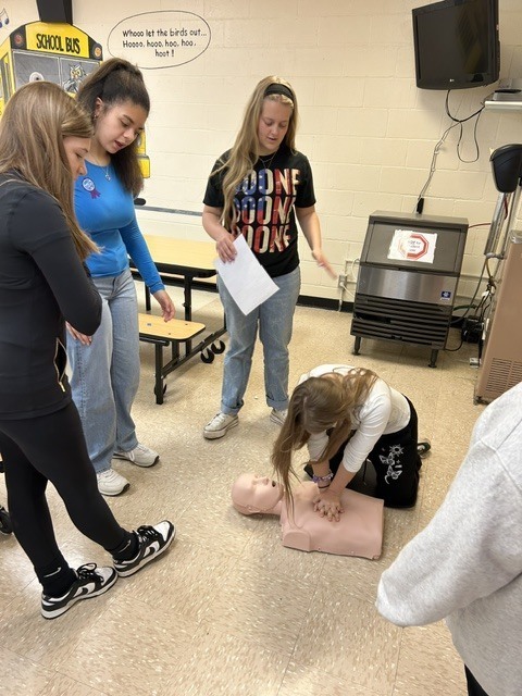 Students practicing CPR on a mannequin