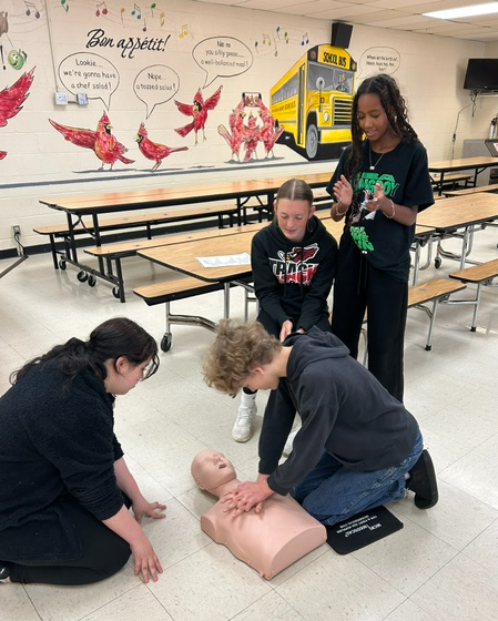 Students practicing CPR on a mannequin