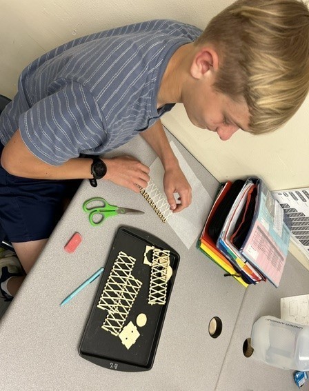 Student assembles his lantern parts