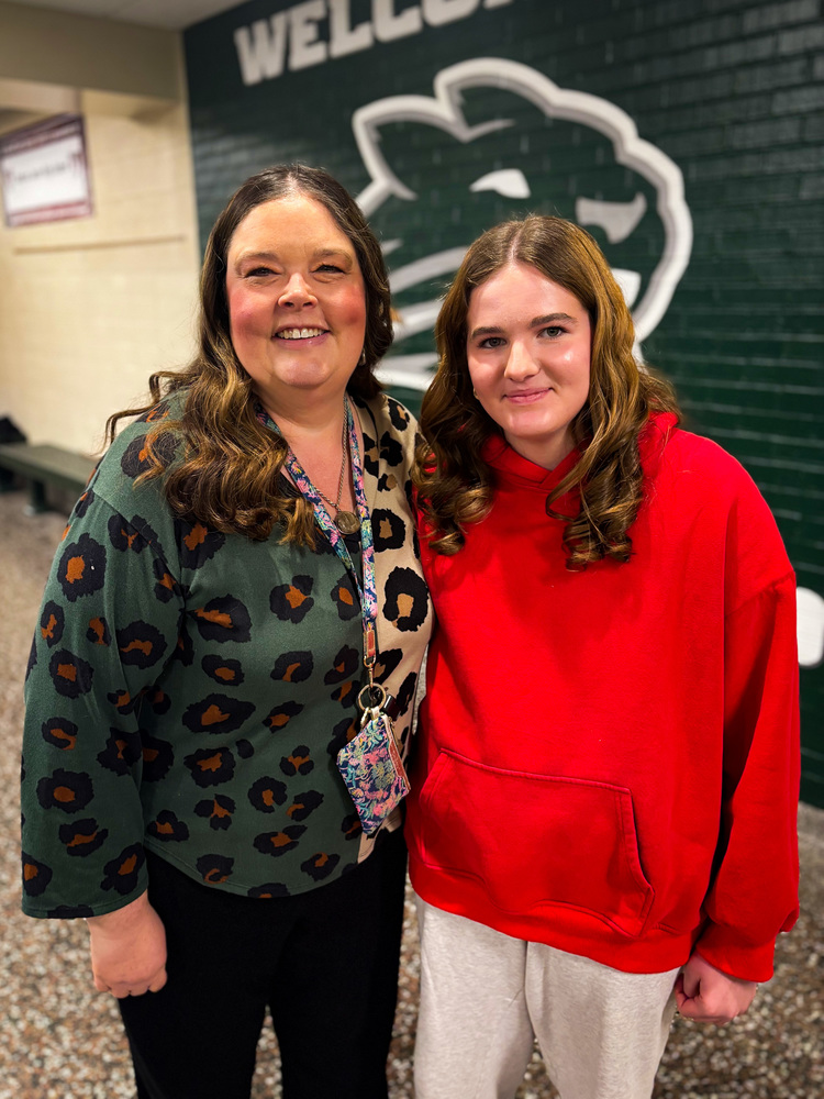 Student posing with teacher