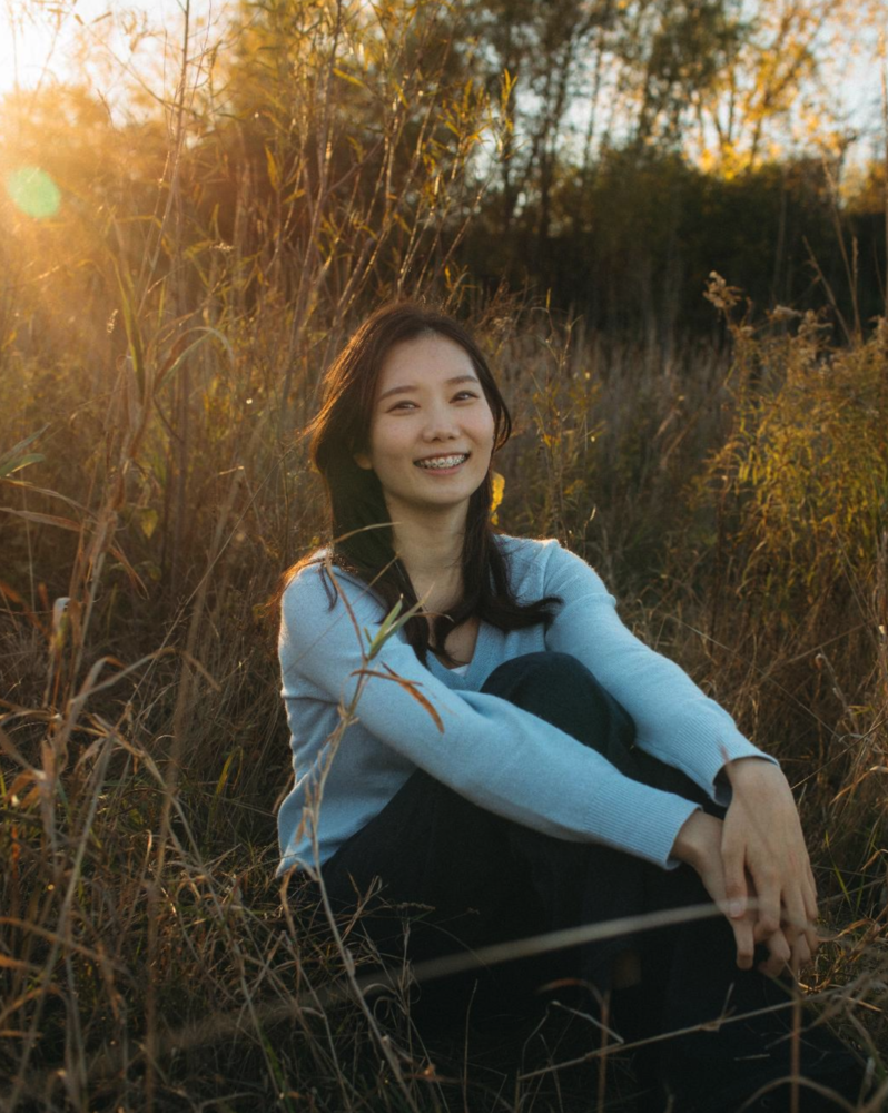 Student posing in field