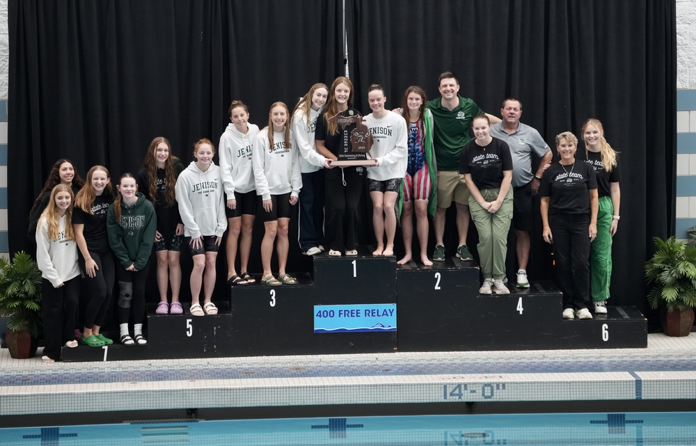 Girls swim and dive team holding runner-up trophy
