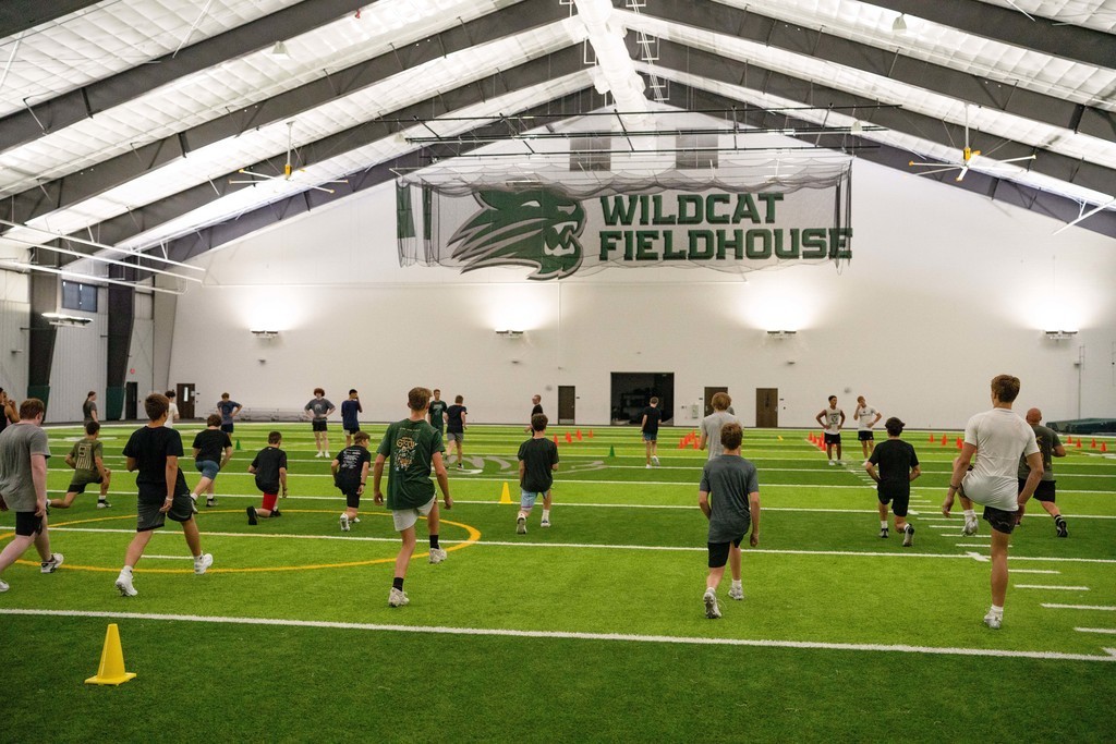 Students stretching on field