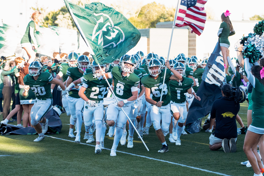 Football players running on field