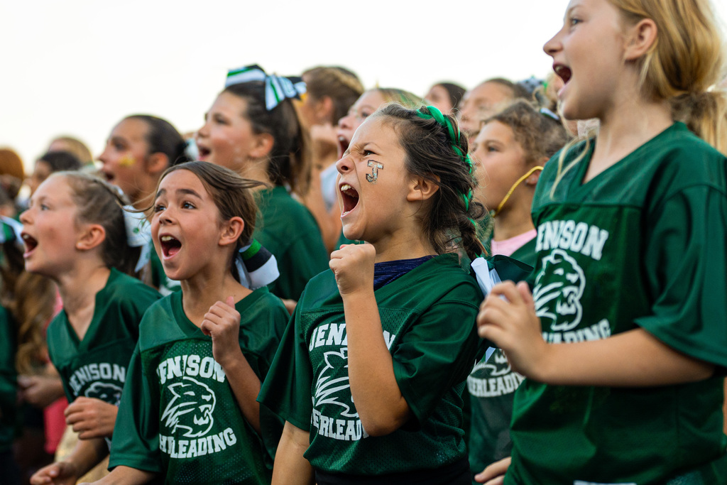 Kids cheering at football game