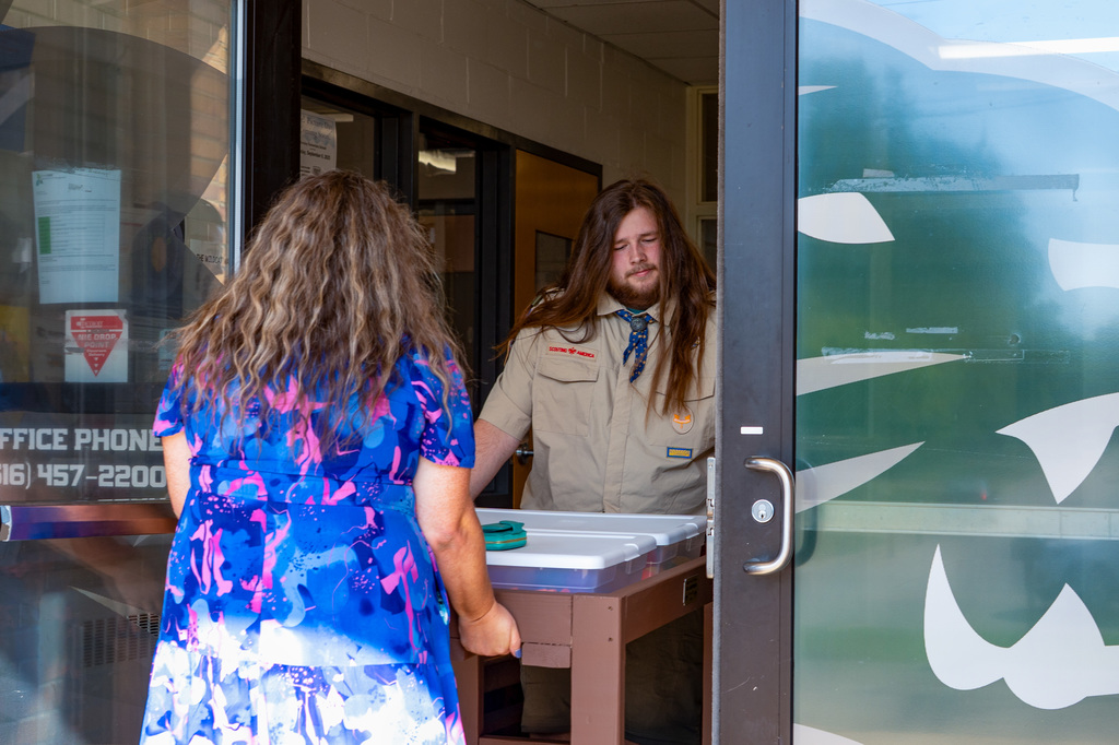 Student and parent bringing table into schoo