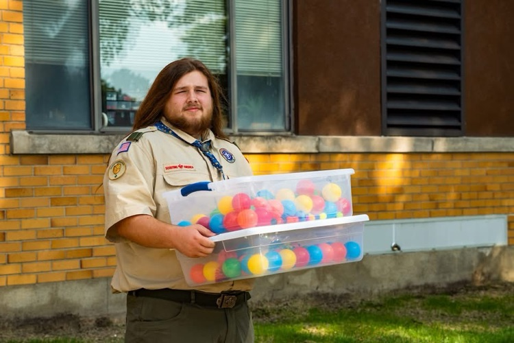 Eli carrying sensory bins