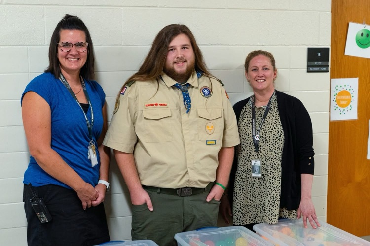 Eli with teacher and principal