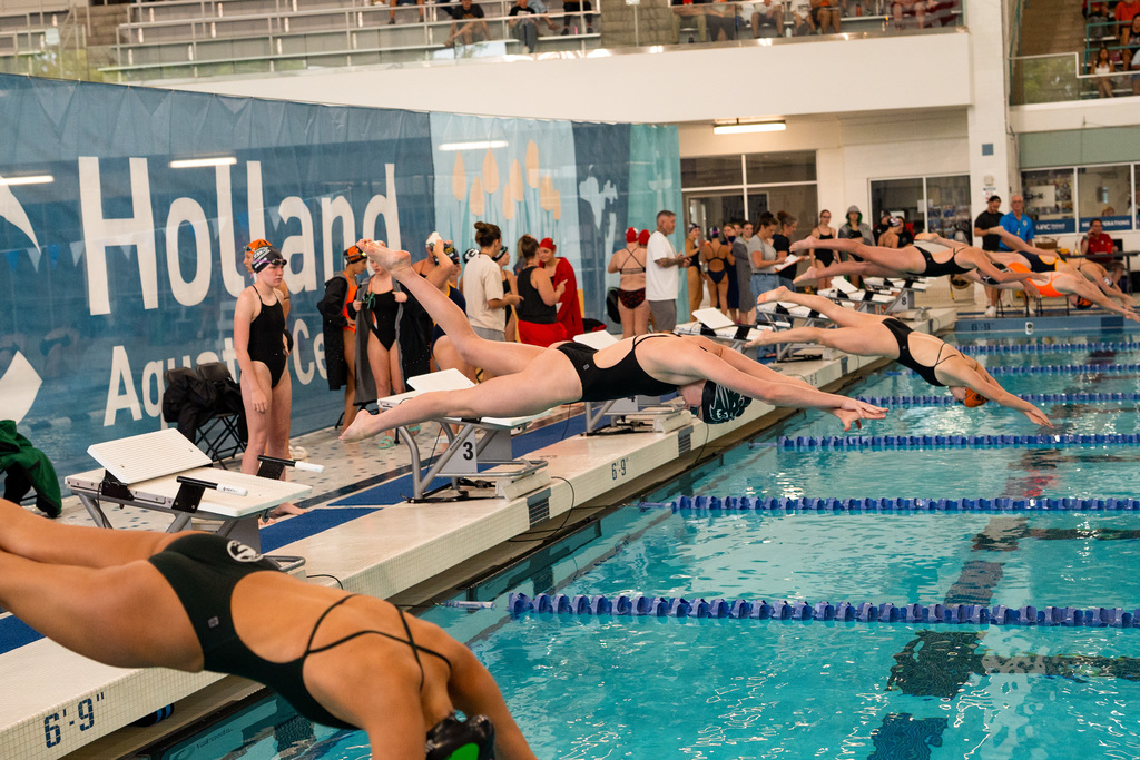 Swimmers jumping in pool