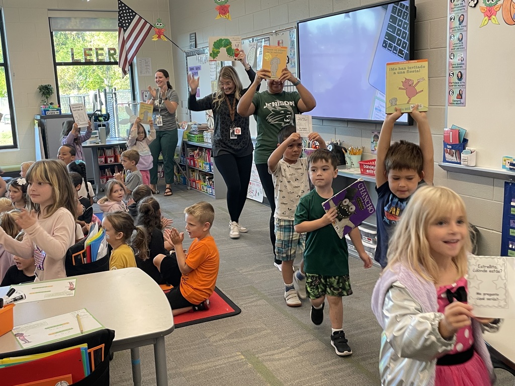 Kindergarteners holding books in a parade