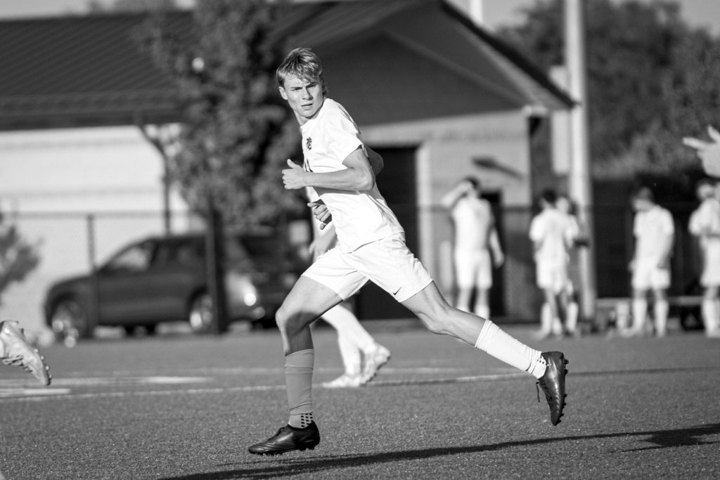 Boys soccer player running