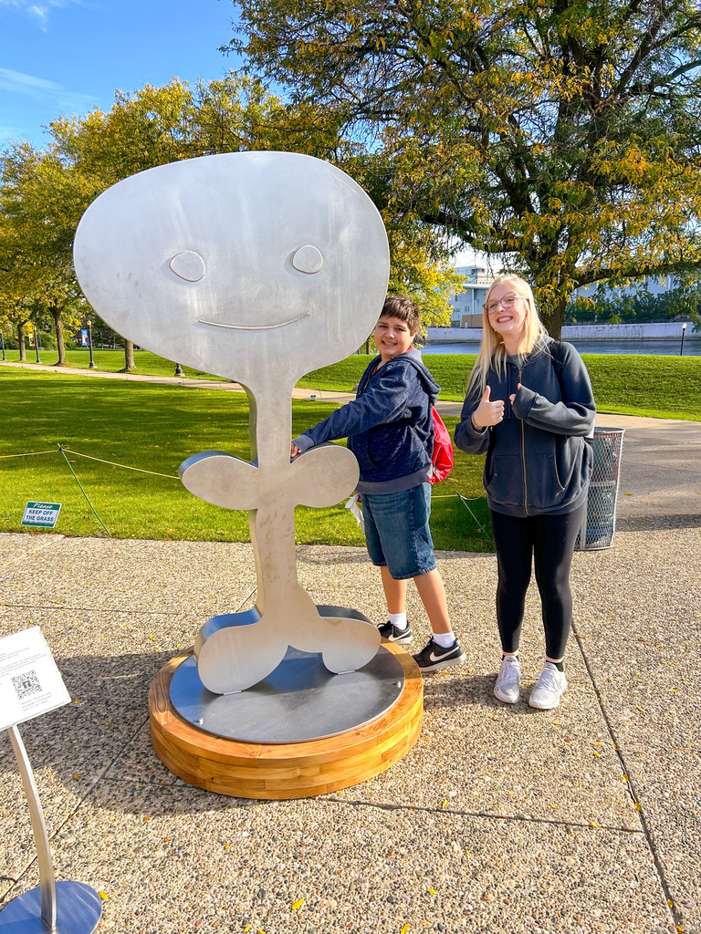 Students posing near art
