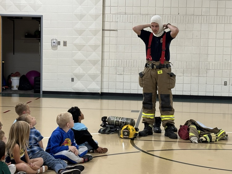 fireman putting on protective gear