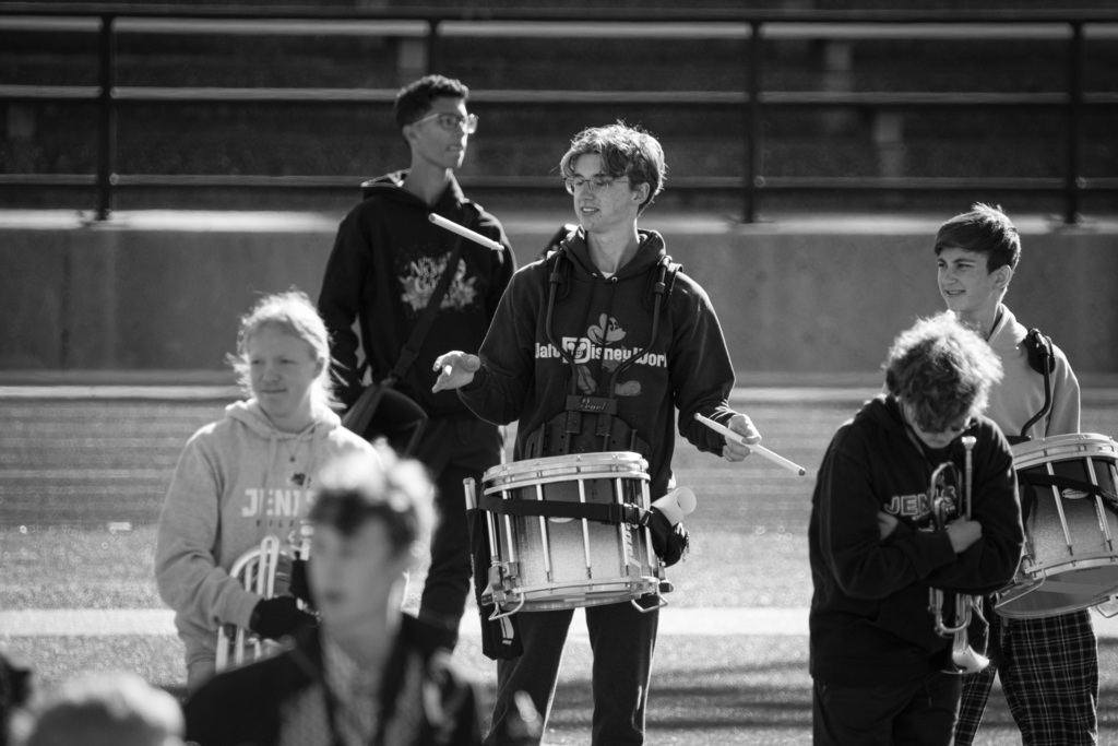 Drumline throwing drumstick in the air