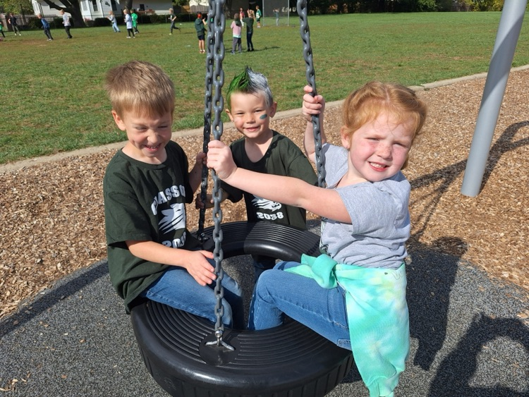 students wearing spirit wear on tire swing