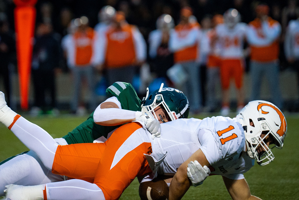 Football sacking quarterback