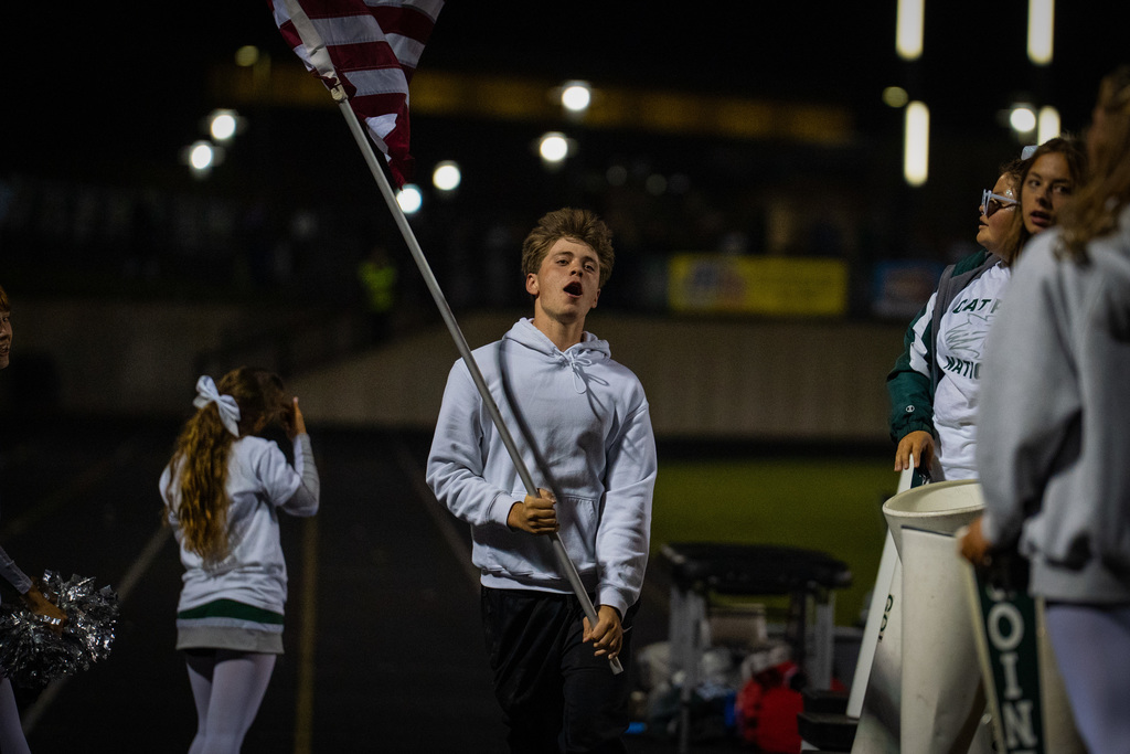 Student running with flag