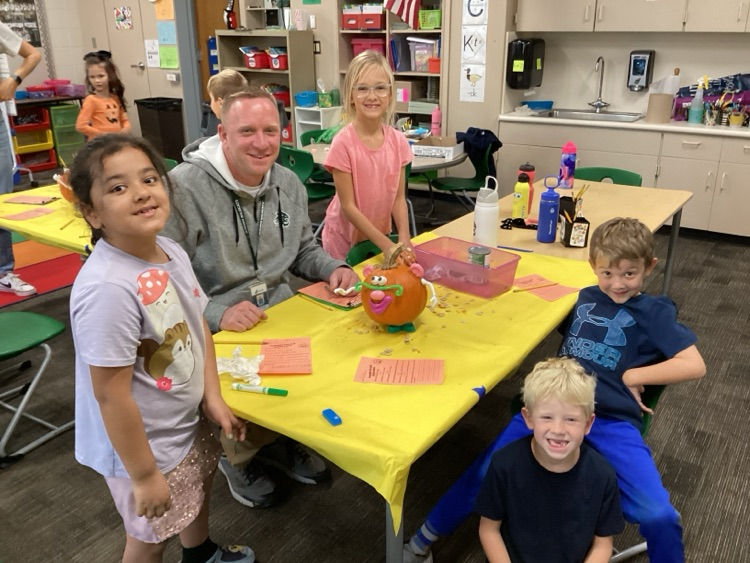 Students and staff with decorated pumpkin