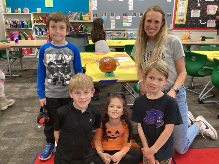 Students and staff with decorated pumpkin