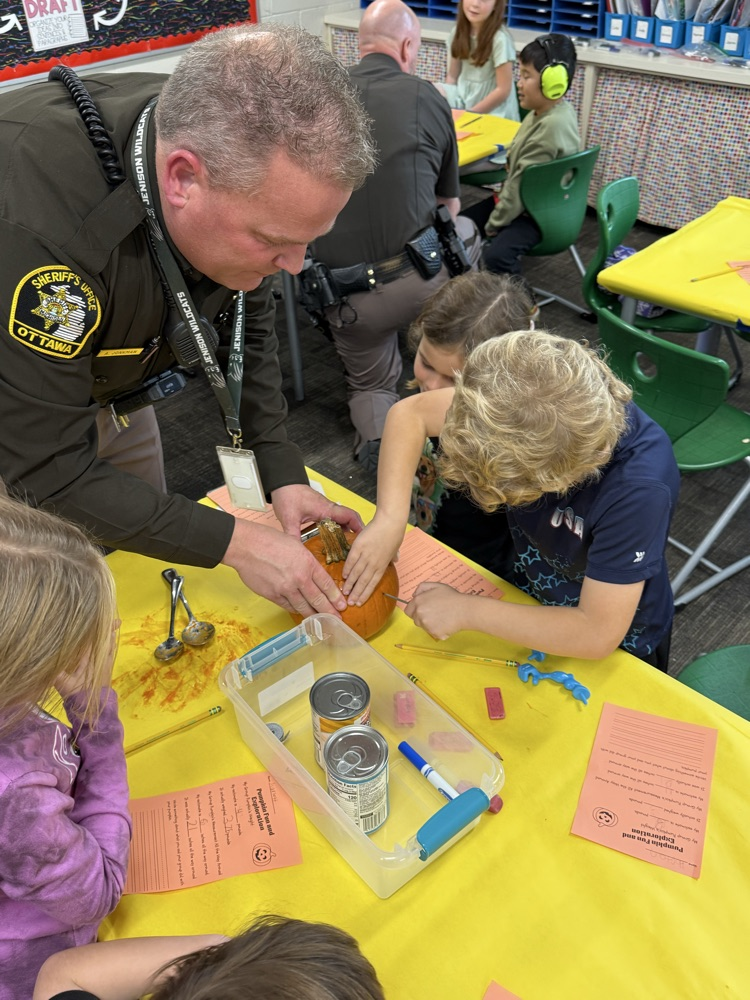 Student gutting pumpkin