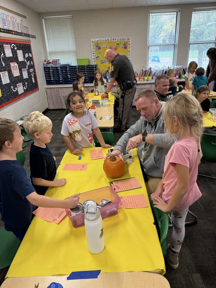staff carving pumpkins with students