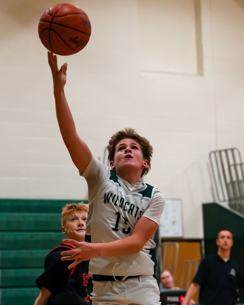 Junior high basketball player shooting basketball