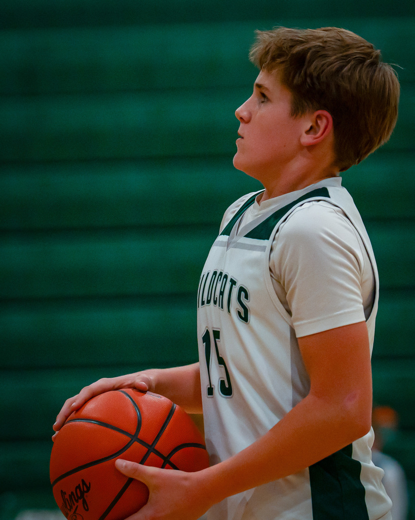Junior high basketball player shooting basketball
