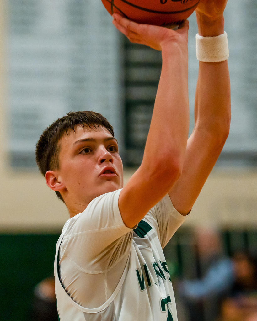 Junior high basketball player shooting basketball