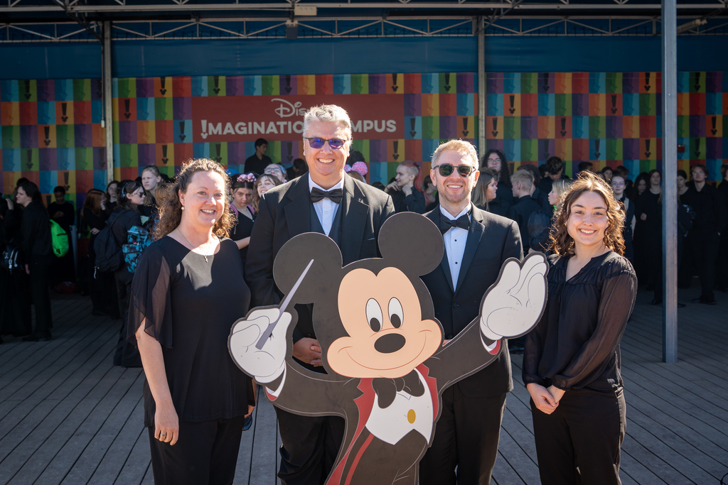 Jenison Orchestra conductors posing with Mickey