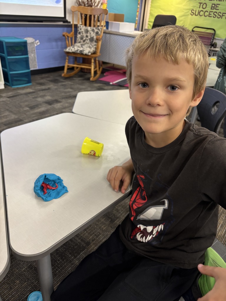 JIA Elementary student making a fossil for a science project