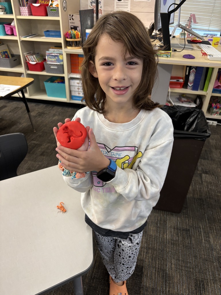 JIA Elementary student making a fossil for a science project