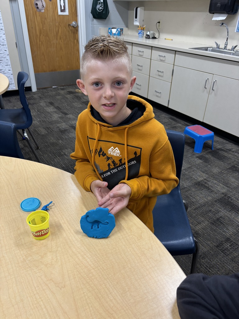 JIA Elementary student making a fossil for a science project