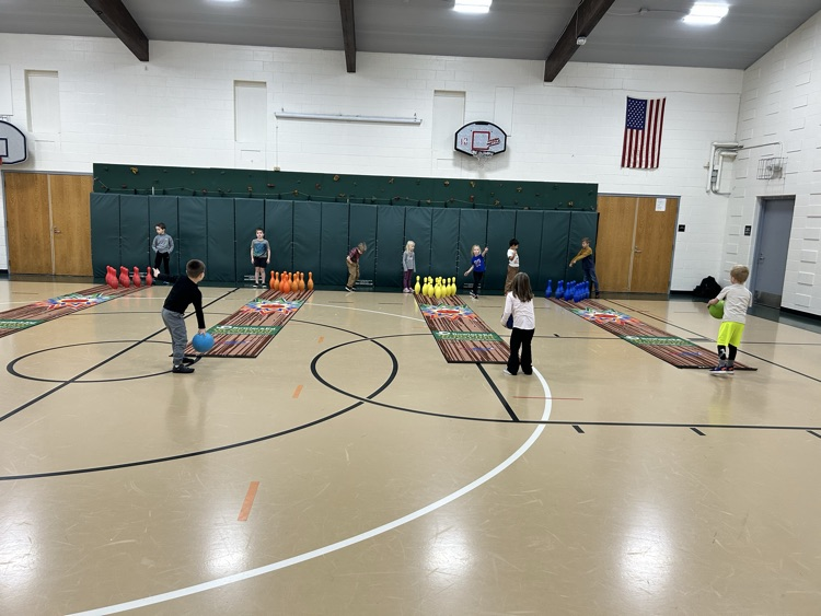 students bowling in gym 