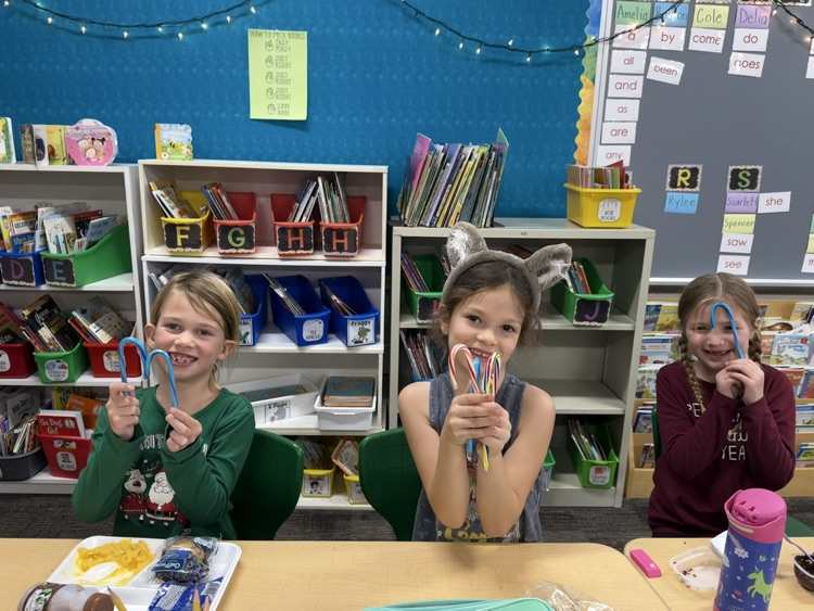 students smiling with candy canes