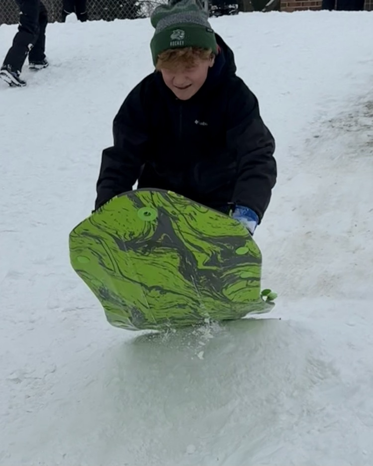 student sledding 