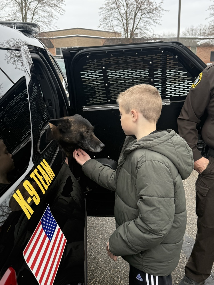 student petting police canine