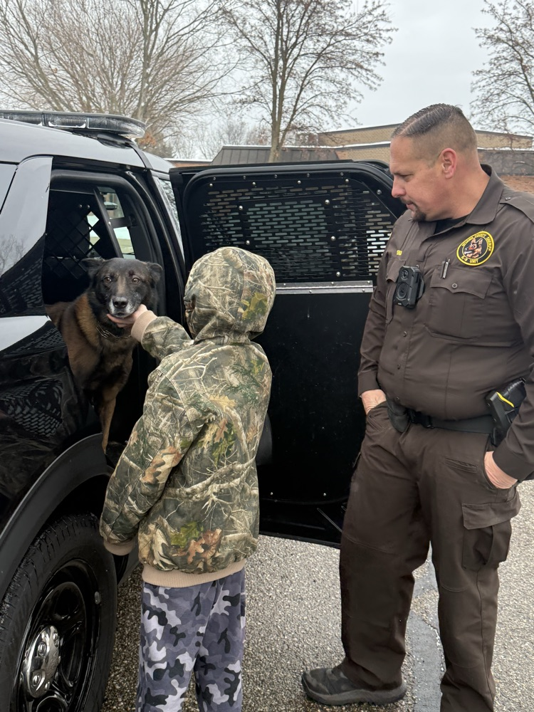 student petting police canine