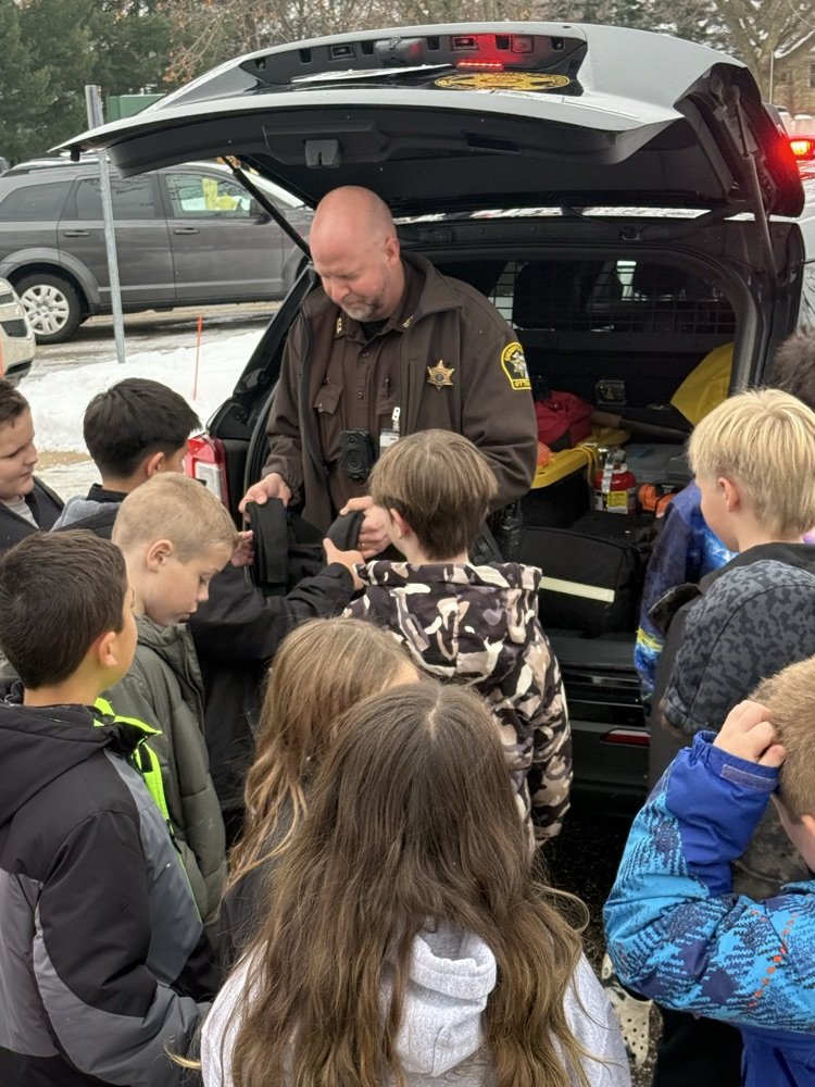 police officer teaching students 