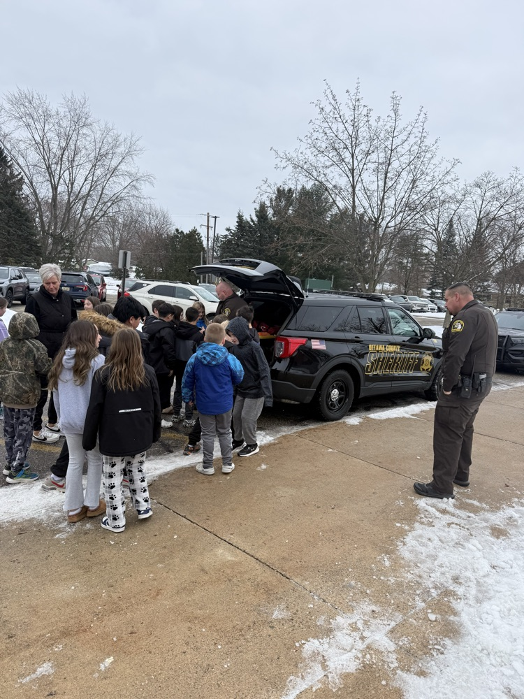students looking at police car