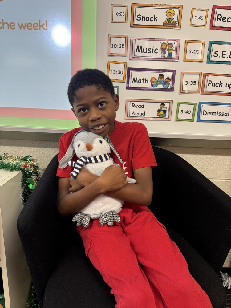 student in red clothes hugging stuffie 
