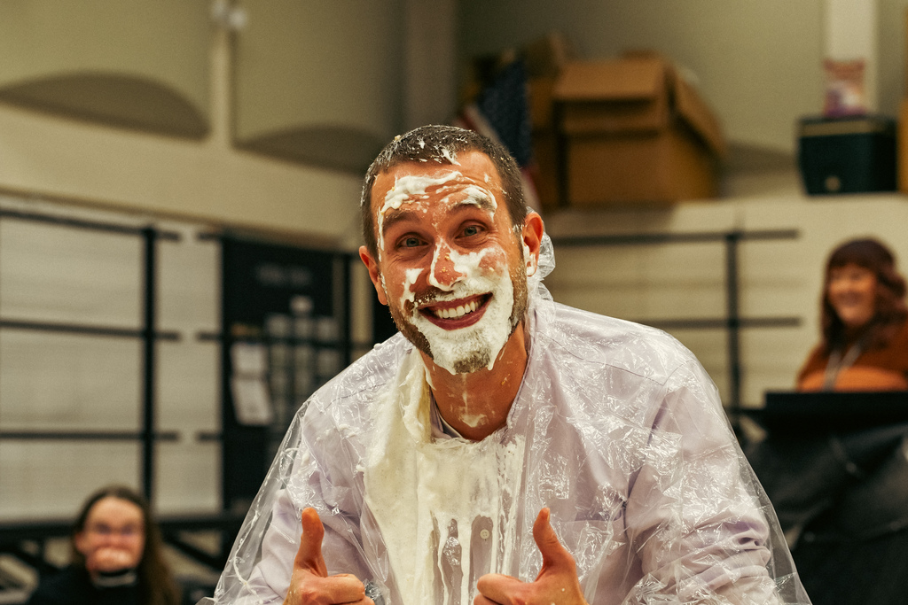 Teacher smiling after getting pied
