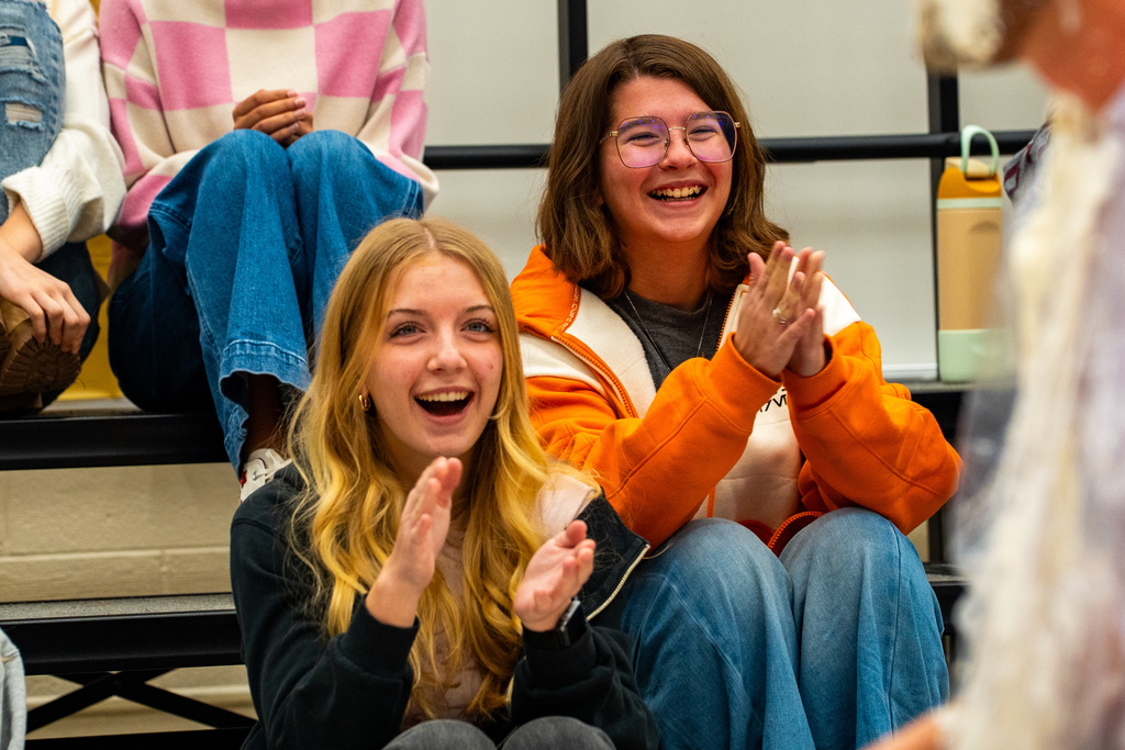 Students cheering on teacher getting pied