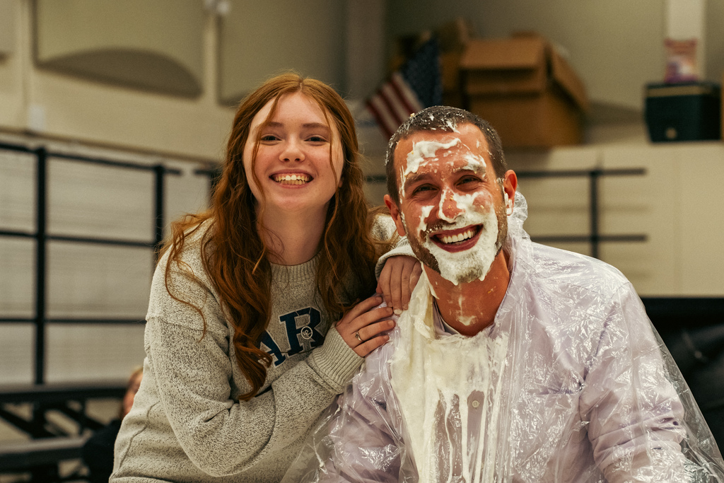 Student posing with pied teacher