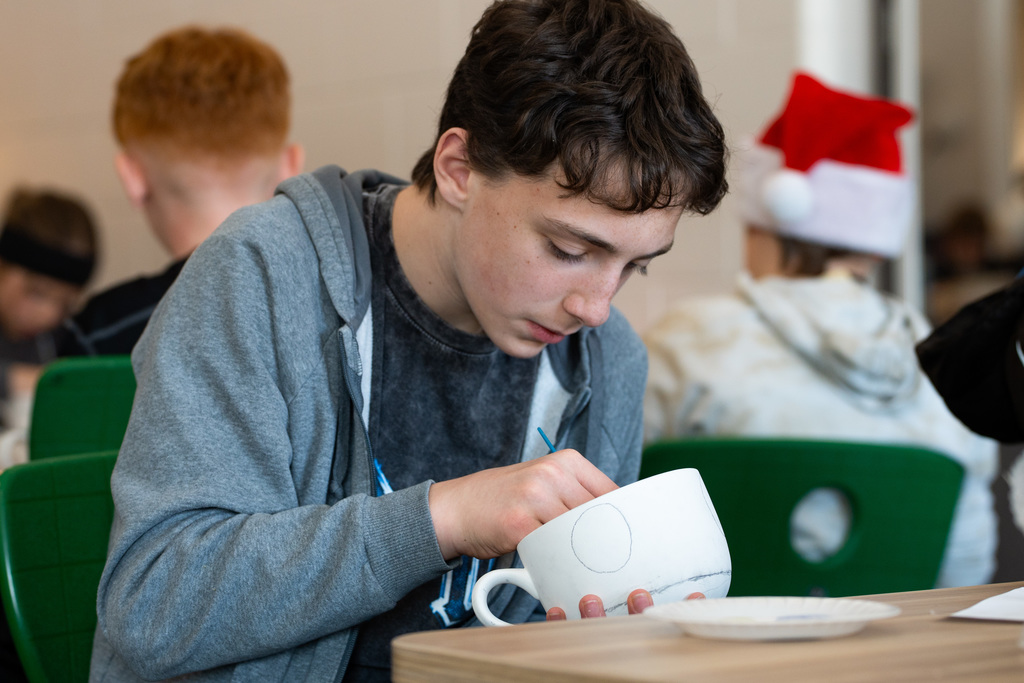 Students painting soup bowls