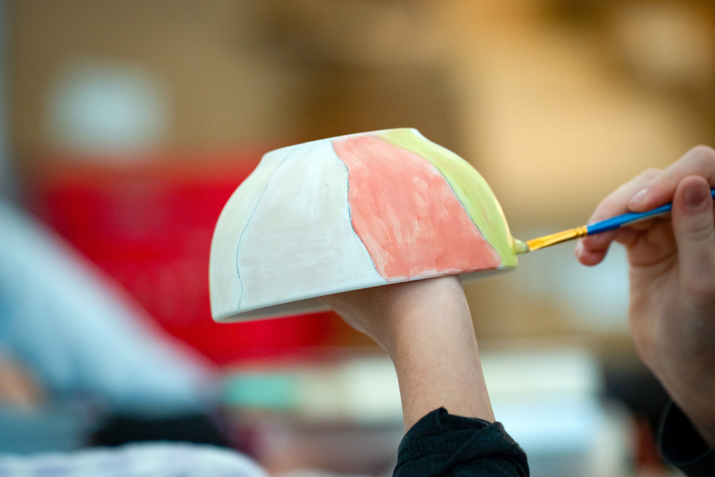 Students painting soup bowls