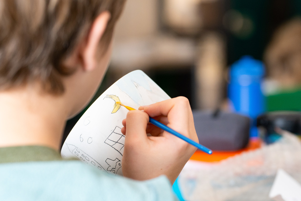 Students painting soup bowls
