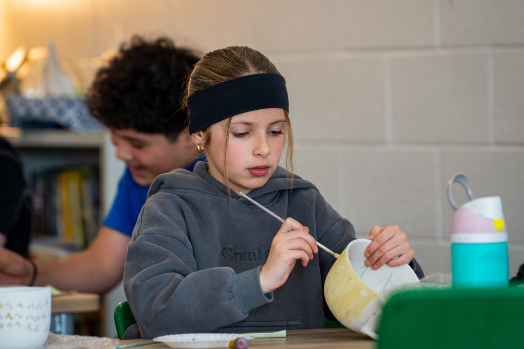 Students painting soup bowls