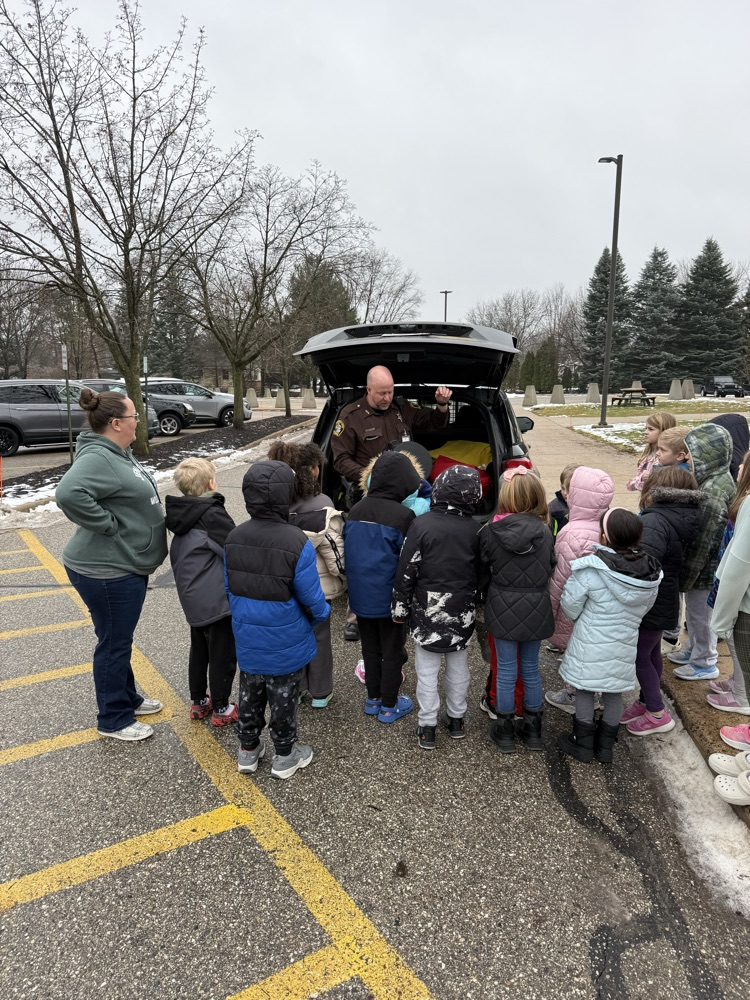 class looking at police car