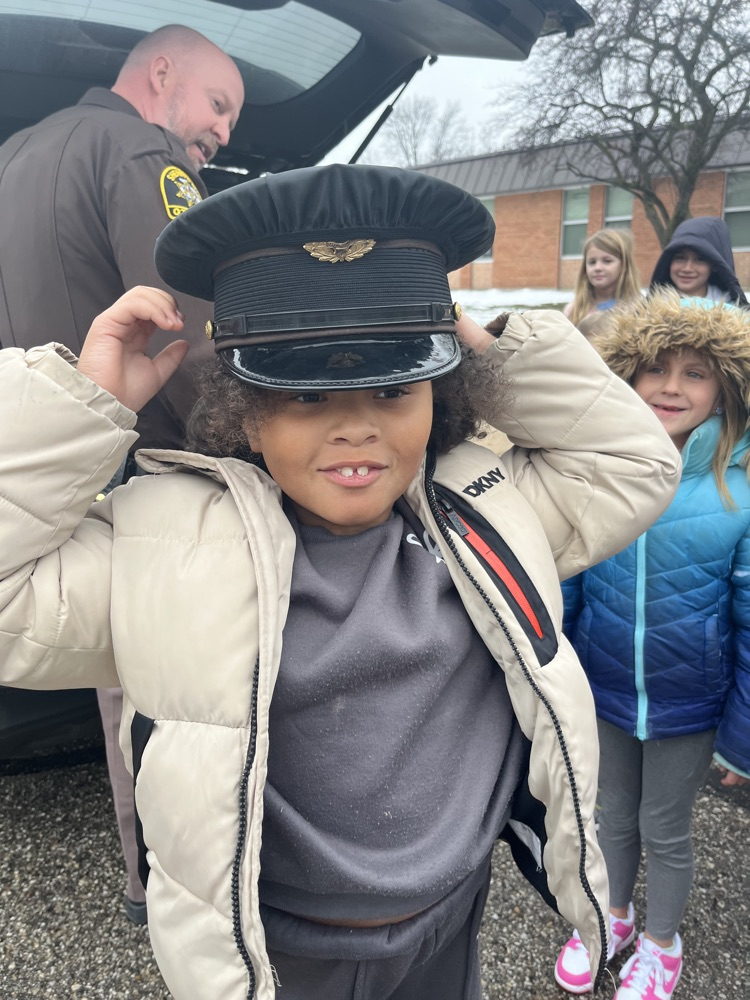 student trying on police hat